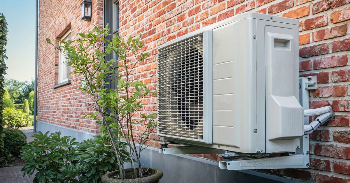 Heat pump on side of building